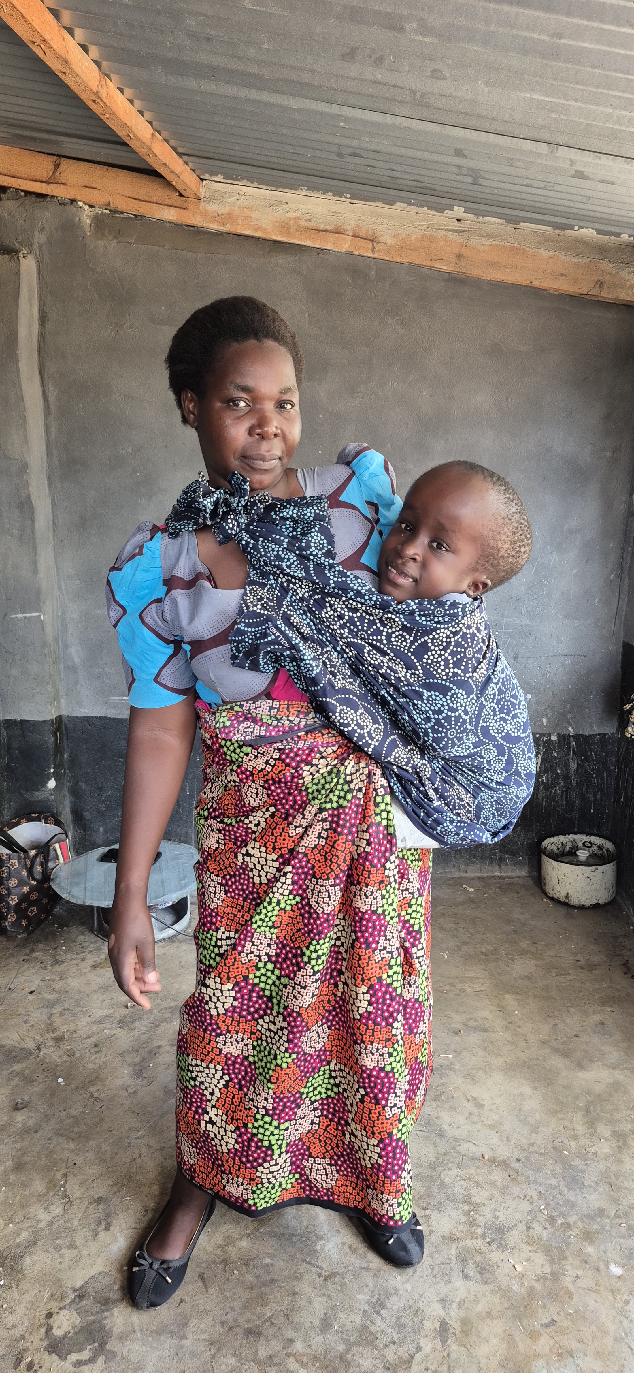 A caregiver holding a young child